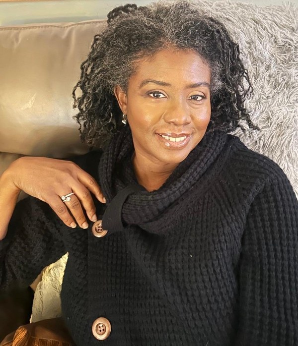 A fan of brushes and open paint tubes on a wooden bench